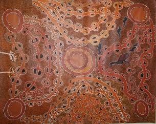 Peter Mungkuri's "Punu" (Wood), relating to the importance of water.  The men have left after collecting punu and making artefacts.  The centre of the painting is filled with water, rockholes and waterholes which are the lifeforce of the desert region.  The arched shapes are wiltjas (shelters).